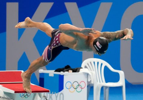 Caeleb Dressel dives into the water during the 2020 Tokyo Olympics, wearing a FINA approved ‘Tech-Suit’.