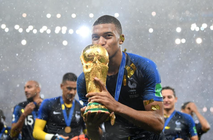Kylian Mbappe kissing the World Cup trophy after winning the title with France in the 2018 World Cup. (Forbes)
